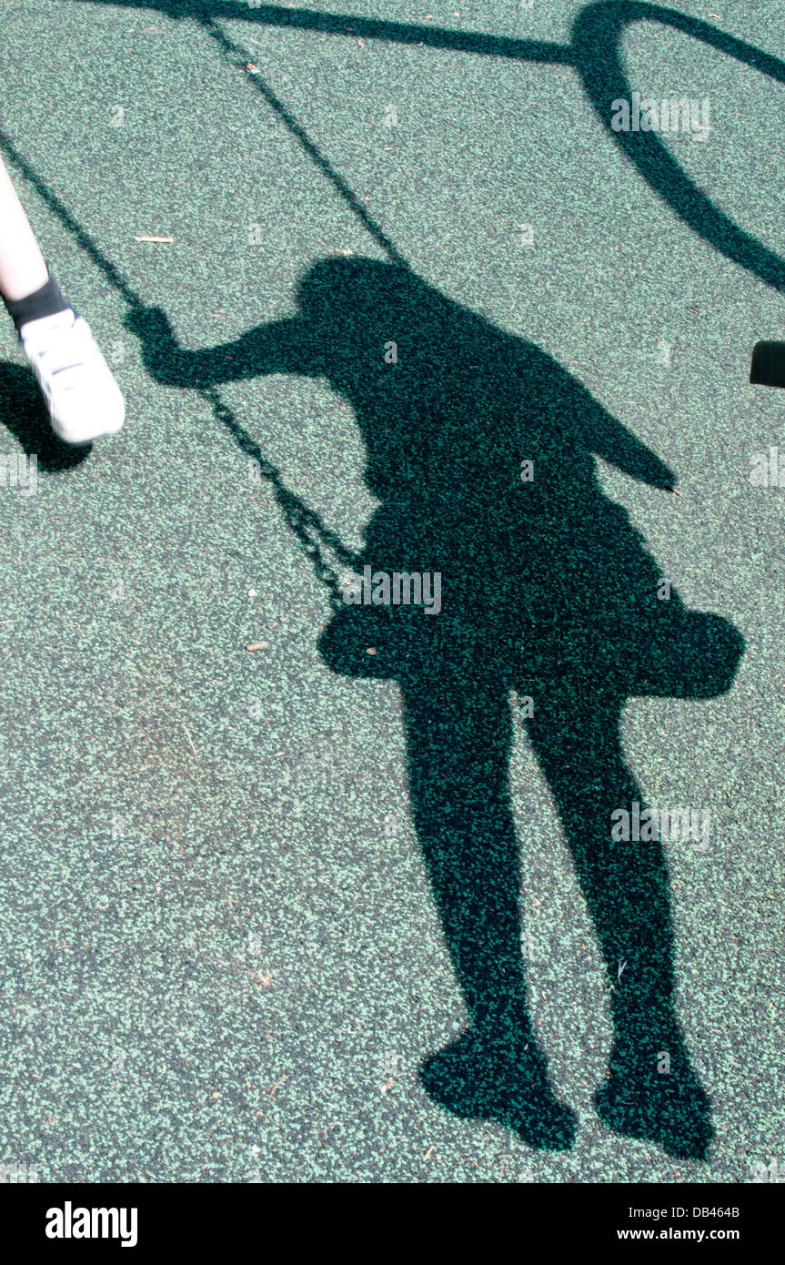 shadow of a girl on a swing Stock Photo