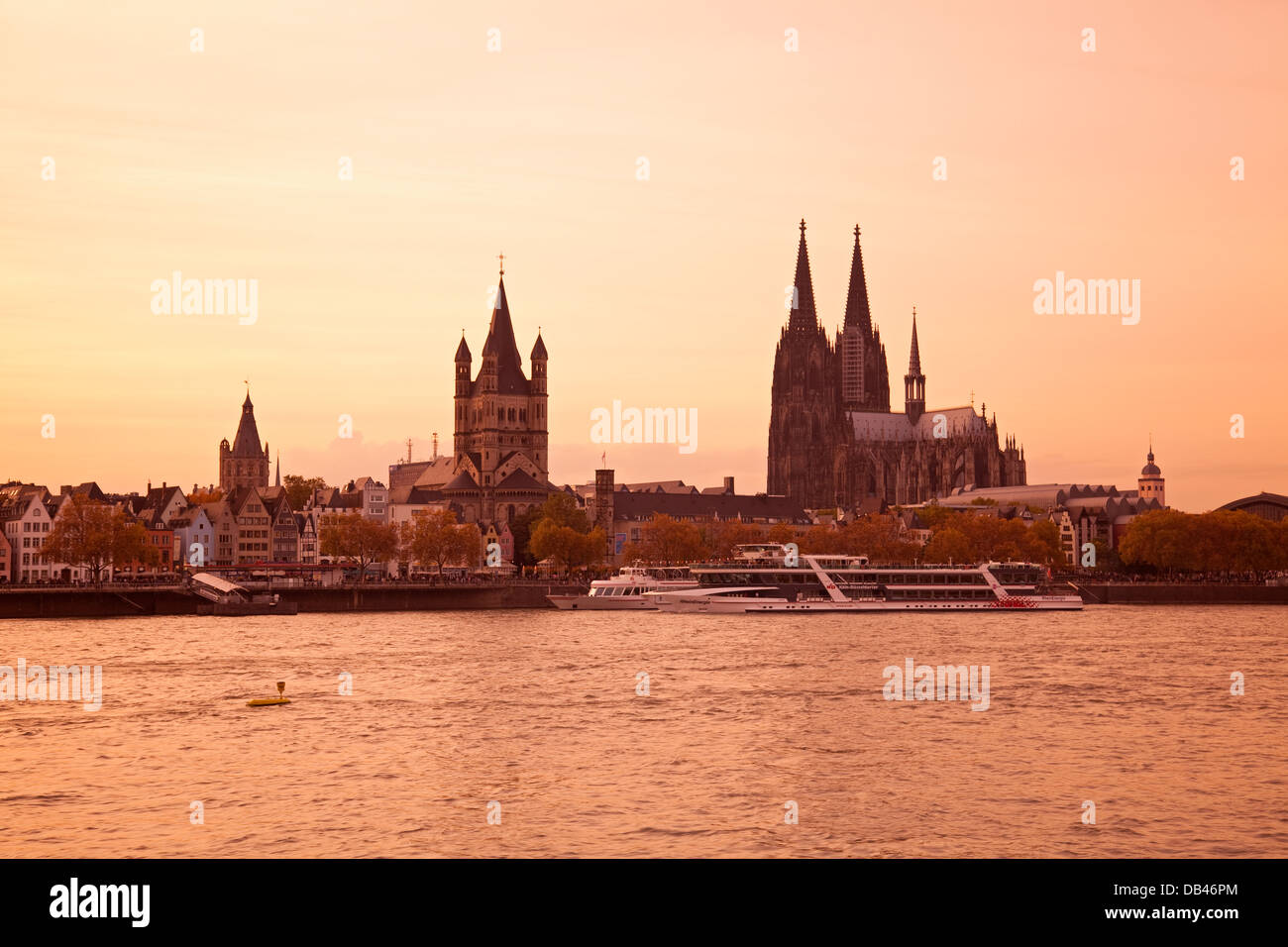 Church of Gross St Martin and Cologne Cathedral with River Rhine at dusk, Cologne, Rhine-Westphalia, Germany Stock Photo