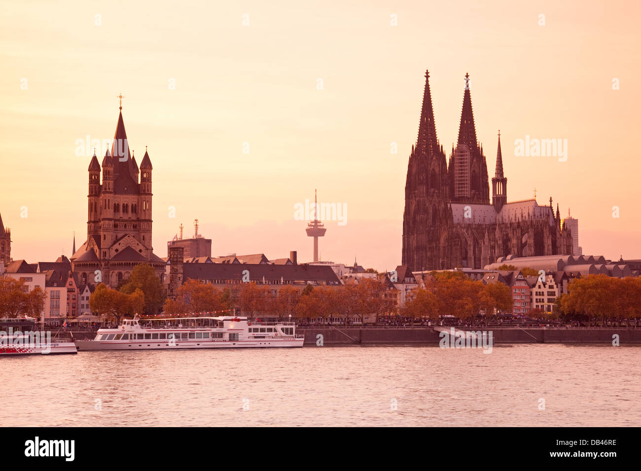 Church of Gross St Martin and Cologne Cathedral with River Rhine at dusk, Cologne, Rhine-Westphalia, Germany Stock Photo