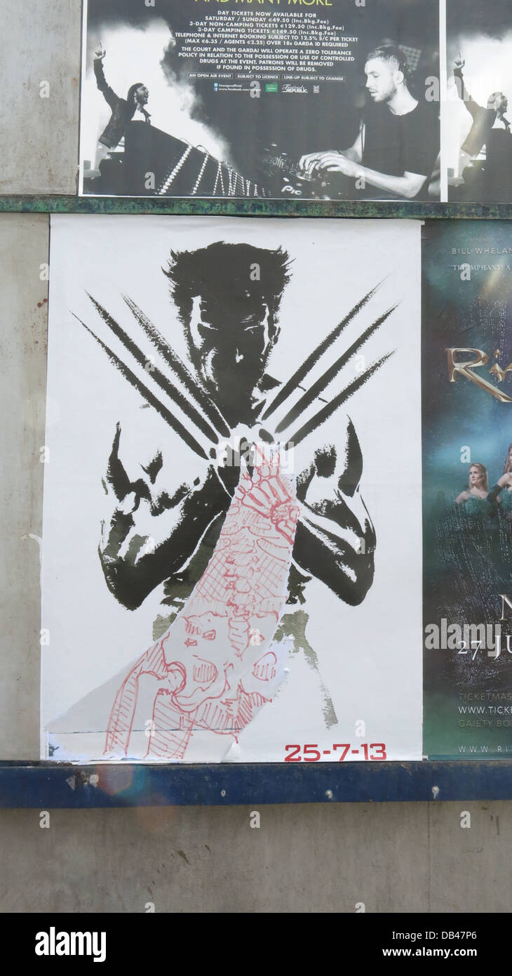 Image Of A Promotional Poster With Graffiti On A Dublin City Wall For The New Movie The Wolverine Starring Hugh Jackman Stock Photo Alamy