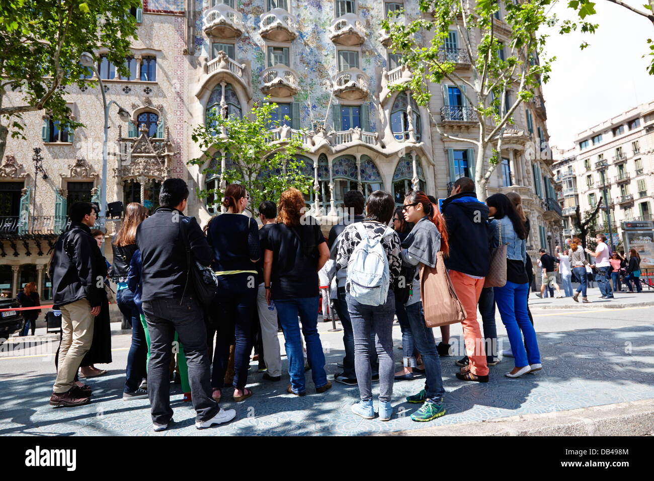 tourists tour group outside casa batllo modernisme style building in Barcelona Catalonia Spain Stock Photo