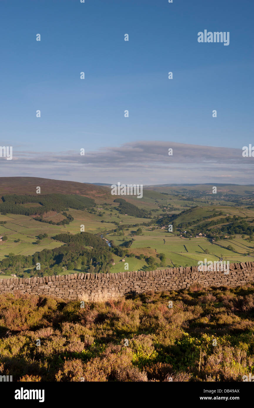 High viewpoint, looking over scenic, green rolling farmland & undulating hills of Wharfedale in the Yorkshire Dales - near Simon's Seat, England, UK. Stock Photo