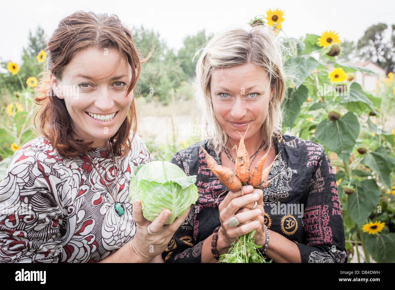 Abigail Sullivan and Kasha Rigby with some vegitables from their garden in Boulder, Utah. Stock Photo