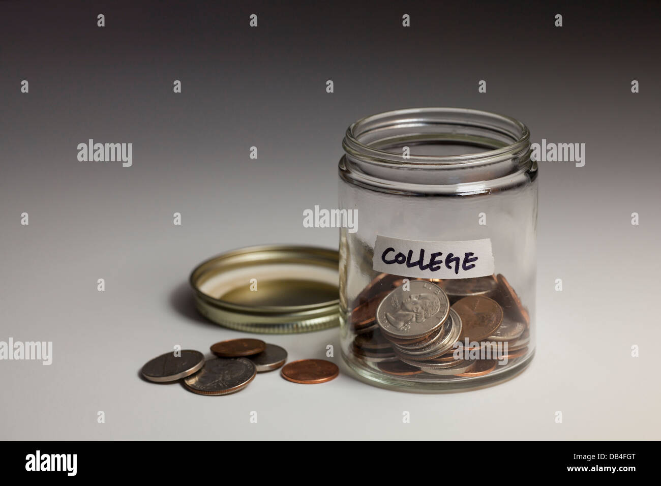 Glass jar of coins saved for college savings - USA Stock Photo
