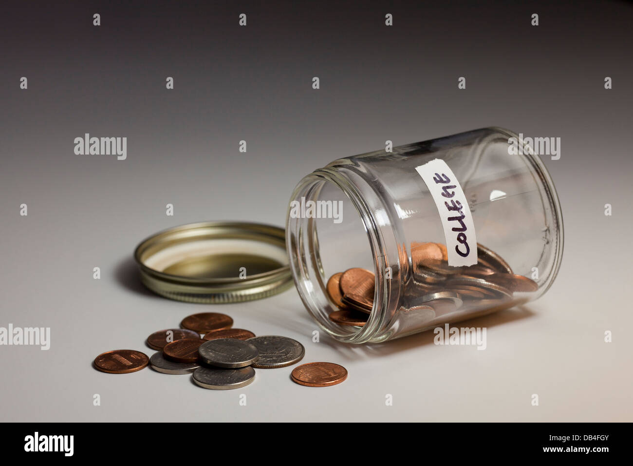 Spilled glass jar of coins saved for college - USA Stock Photo