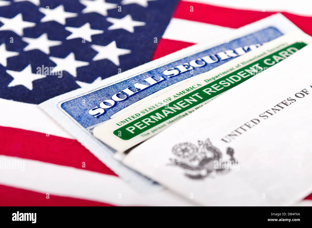 United States of America social security and green card with US flag on the background. Immigration concept. Stock Photo