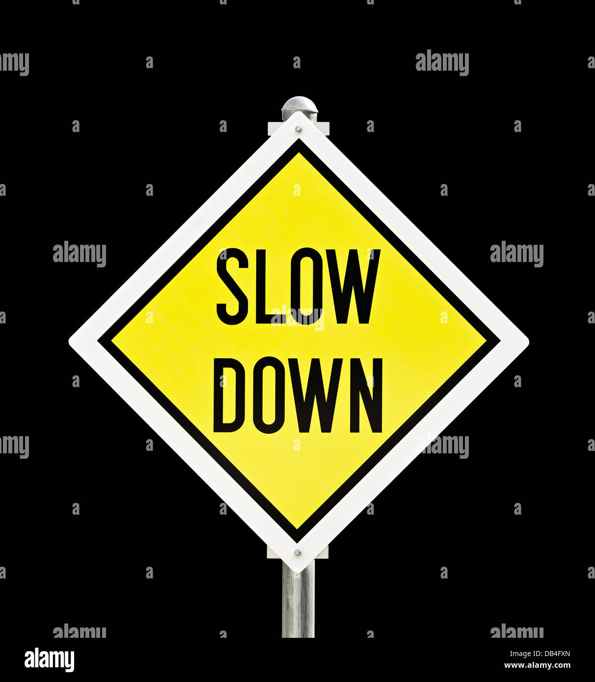 Slow Down yellow road sign isolated over black background Stock Photo