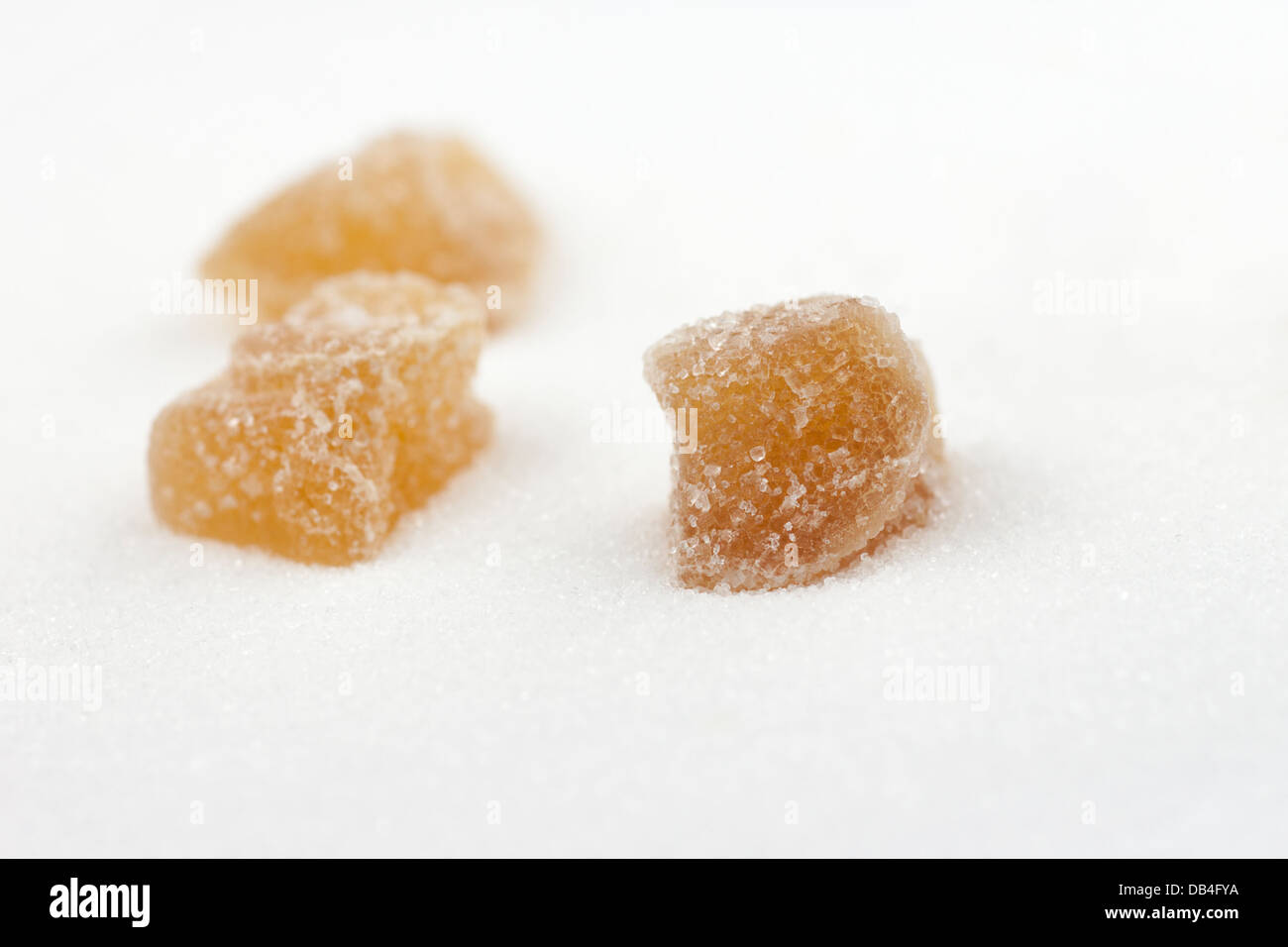 Candied ginger on a background of white sugar Stock Photo