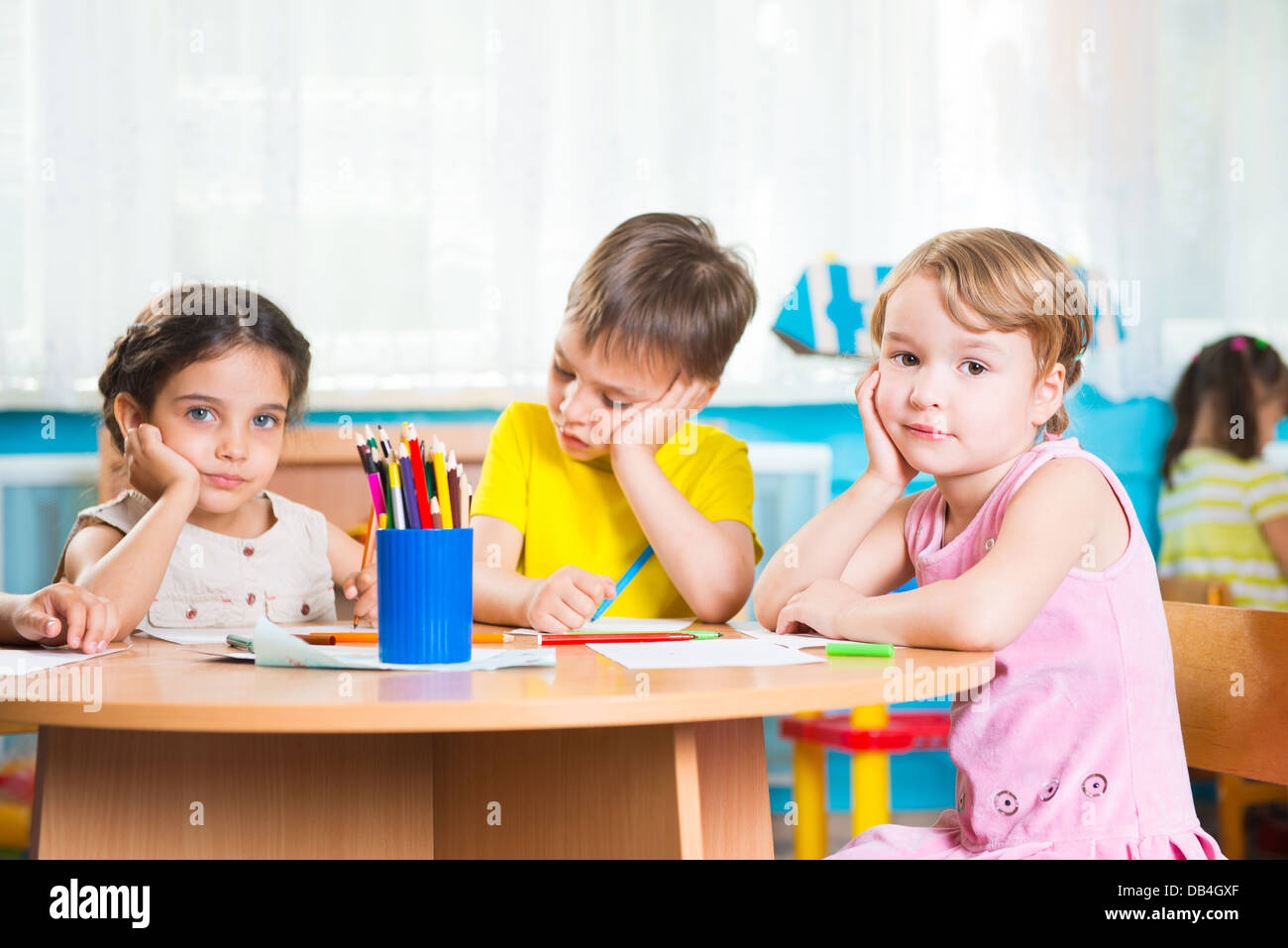 Group of cute little prescool kids drawing with colorful pencils Stock ...