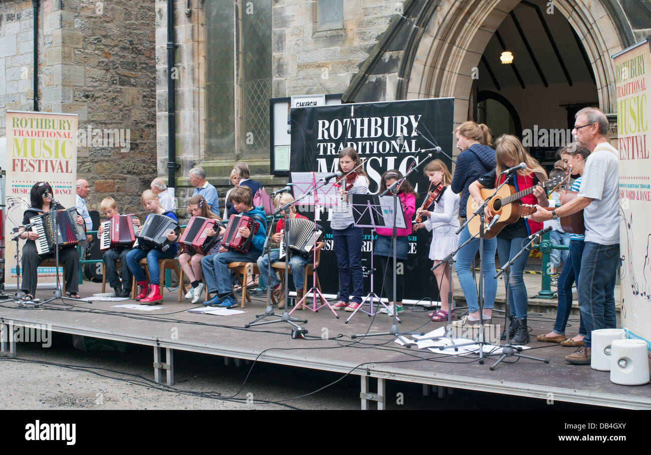 Children's band Keep Calm and Ceilidh On Kids at the Rothbury Traditional Music Festival, northern England, UK Stock Photo