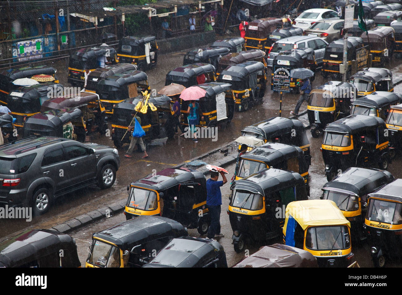 A rickshaw traffic outside the train station caused by a sudden monsoon rainfall and thunderstorm in Bandra, Mumbai, India. Stock Photo