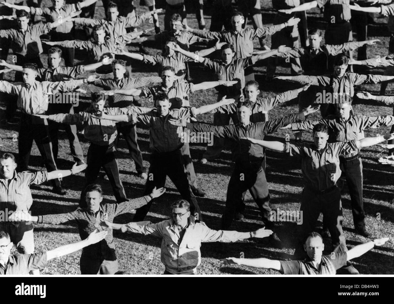 military, Australia, army, basic training, recruits, still wearing civilian clothes, during gymnastics, early-morning exercise, sports, soldiers, soldier, Second World War / WWII, ally, the Allies, Commonwealth, troop, troops, armed forces, defence system, army, armies, military service, military duty, general conscription, 20th century, Australian, Aussie, Australians, Aussies, mobilization, historic, historical, people, 1930s, 1940s, Additional-Rights-Clearences-Not Available Stock Photo