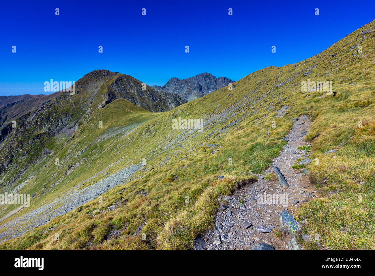 Landscape with mountain trail and clear blue sky Stock Photo - Alamy