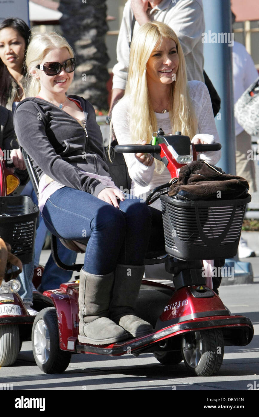 Playboy bunnies, Anna Berglund and Crystal Harris, riding a mobility scooter whilst enjoying a day out at Disneyland Los Angeles, California - 21.04.11 Stock Photo