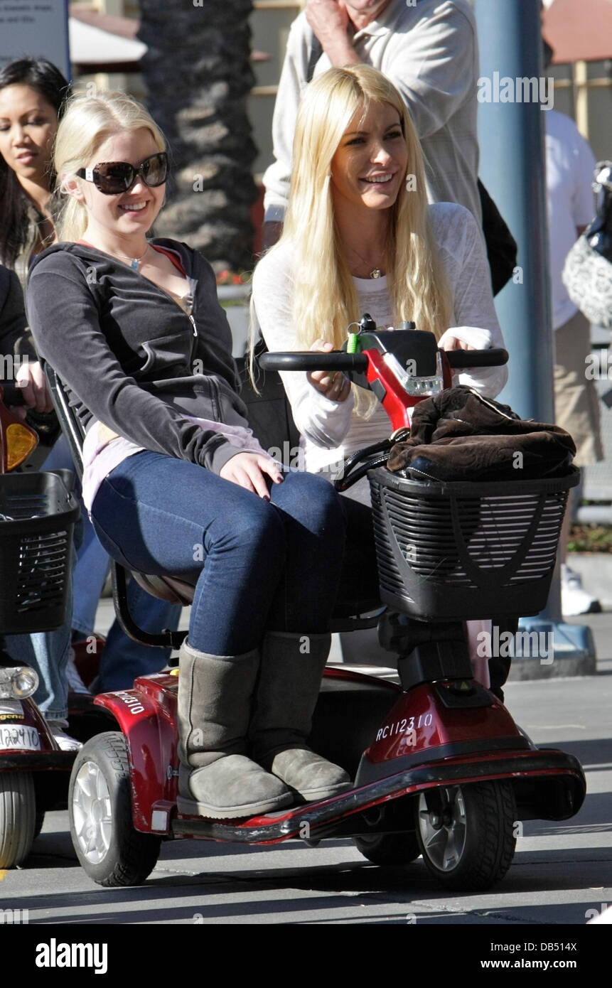 Playboy bunnies, Anna Berglund and Crystal Harris, riding a mobility