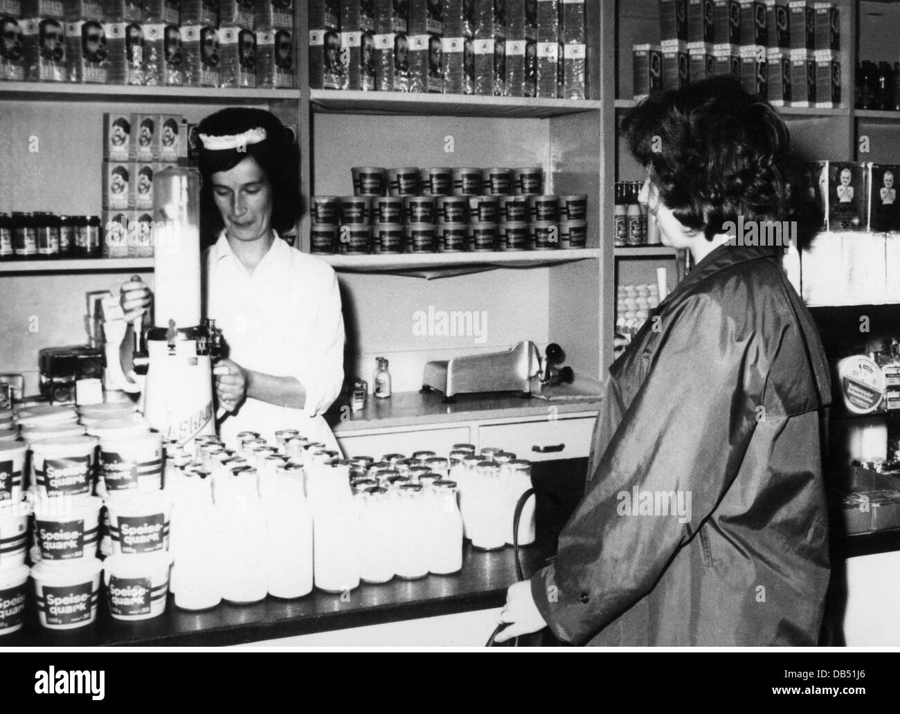 trade, food, milk, hygienic selling of milk at the East German Handelsorganisation (Trade Organisation), Berlin, 1960s, 20th century, geography / travel, Eastern Germany, milk shop, dairy product, dairy products, cascade, cascades, saleswoman, saleswomen, salesladies, customer, customers, shelf, shelves, curd, curd cheese, regular quark, retail trade, retailing, retail and wholesale, retail, food, foodstuff, East-Germany, East Germany, GDR, DDR, 60s, historic, historical, female, woman, women, people, Additional-Rights-Clearences-Not Available Stock Photo