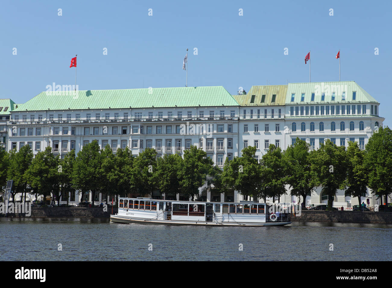 A boat cruises on the Inner Alster lake (Innenalster) in Hamburg, Germany. Stock Photo
