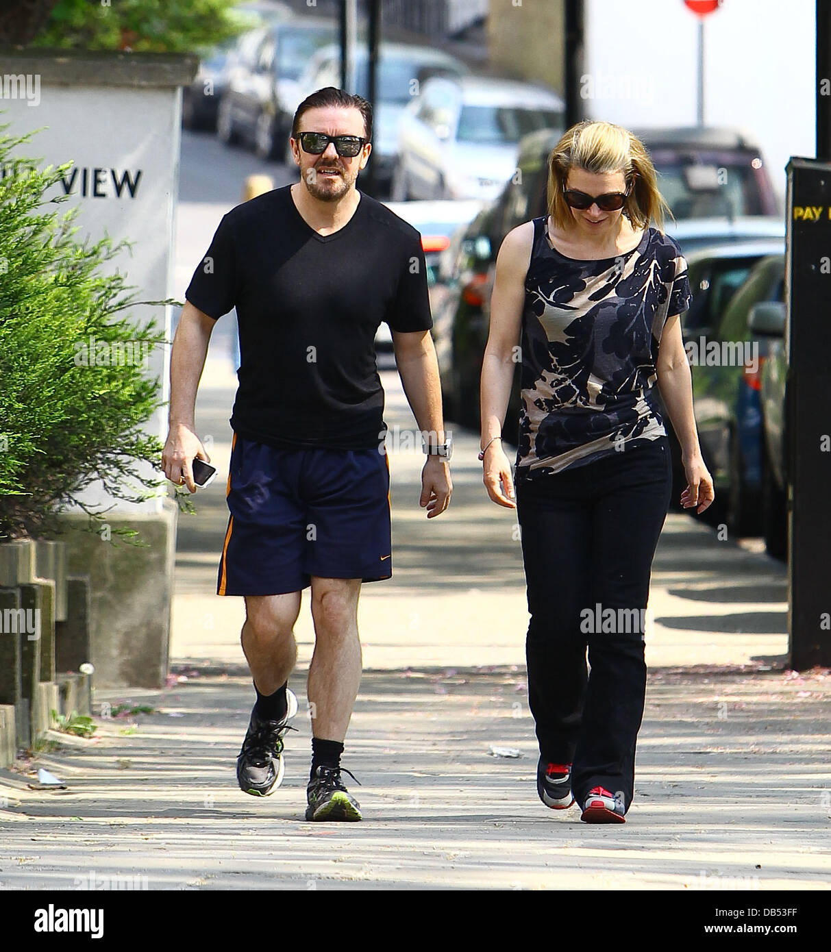 Ricky Gervais and his girlfriend Jane Fallon take a walk through a