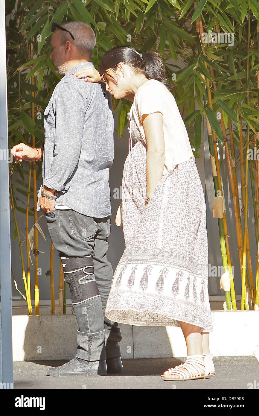 Heavily pregnant Selma Blair in a floralprint dress and sandals with