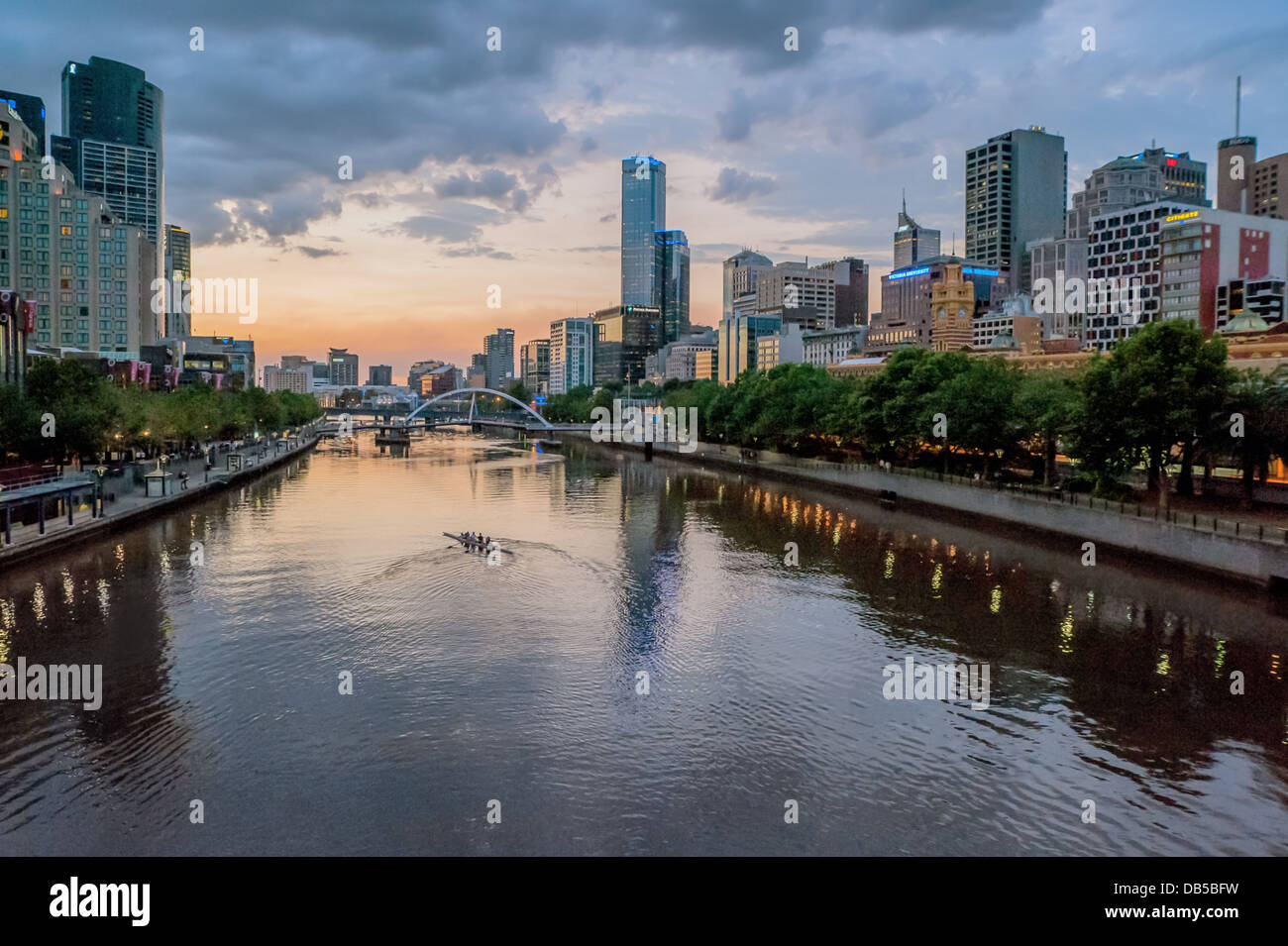 Rowers exercise at sunset on Melbourne's Yarra River. Australia. Stock Photo