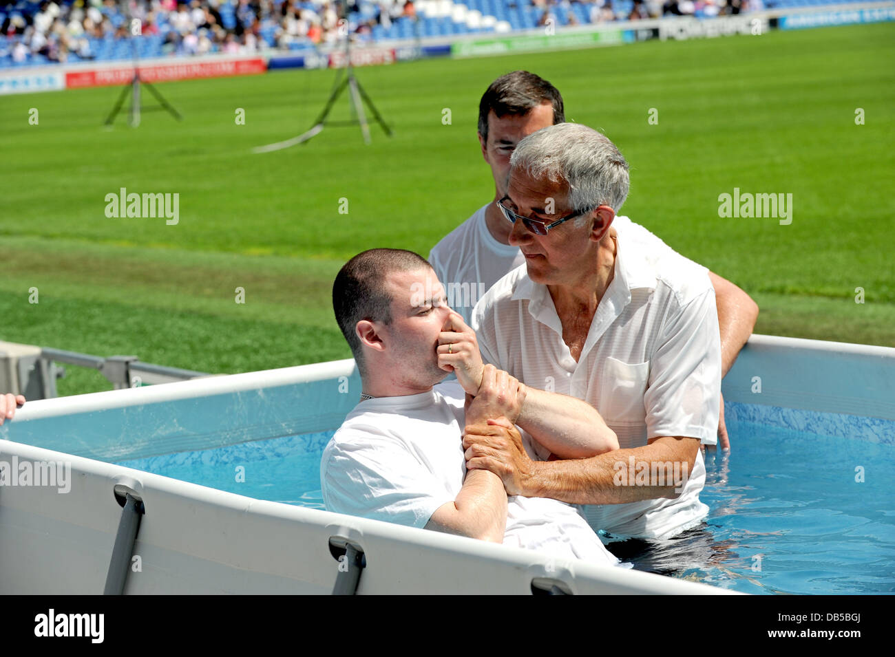 Jehovah’s Witnesses use a special pool to baptise new members into the religion during a Bible-based convention in Sussex Stock Photo
