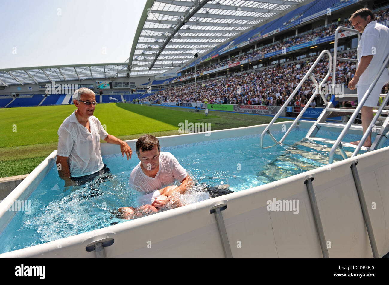 Jehovah’s Witnesses use a special pool to baptise new members into the religion during a Bible-based convention in Sussex Stock Photo