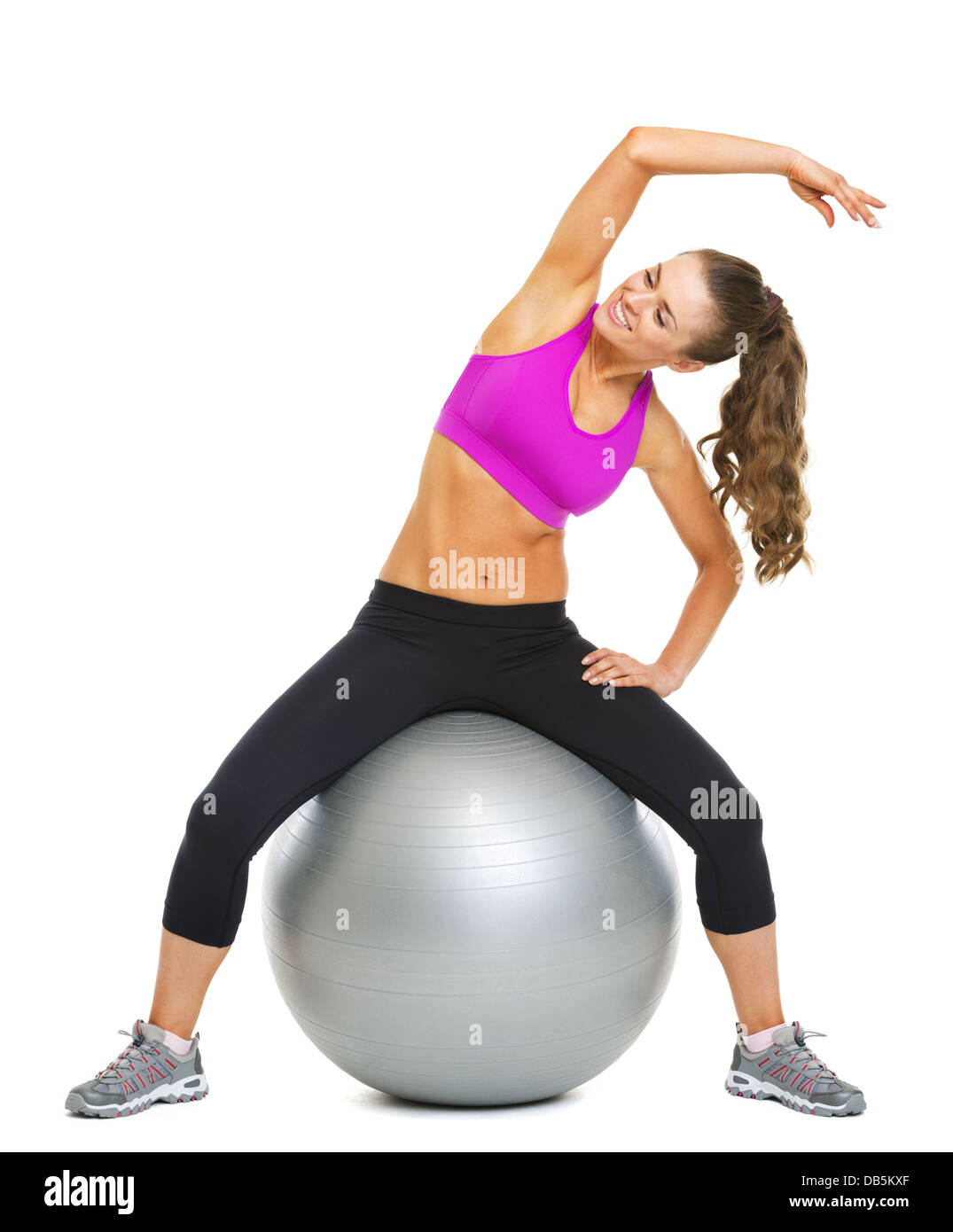 Happy fitness young woman making exercise on fitness ball Stock Photo