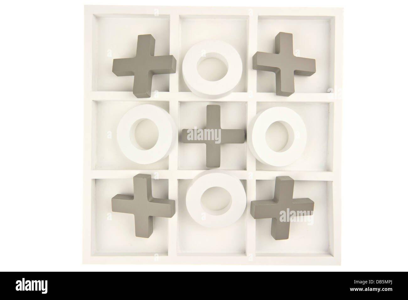 Wooden noughts and crosses game board in gray and white colors and playing stones ornate in cross shape and isolated Stock Photo