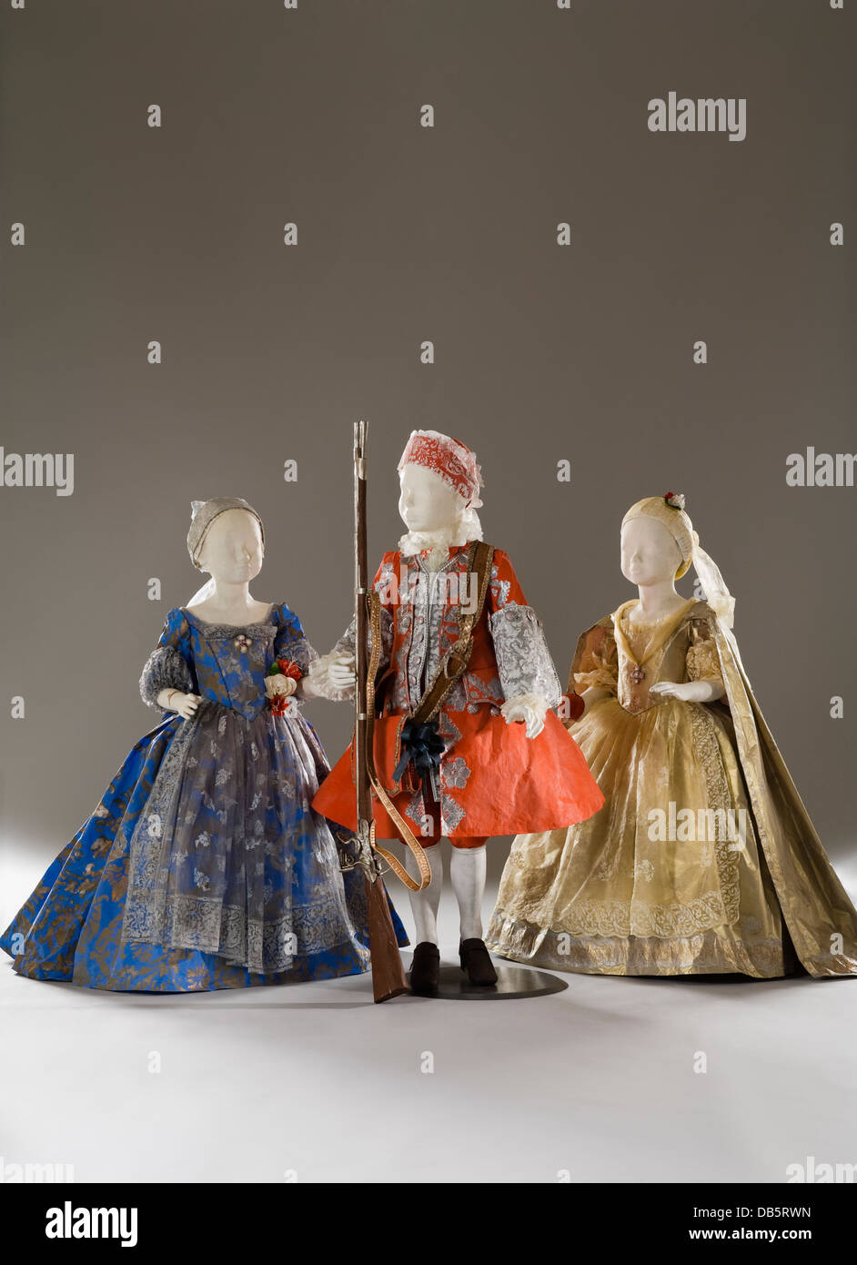 Three child mannequins in paper dress costumes Stock Photo