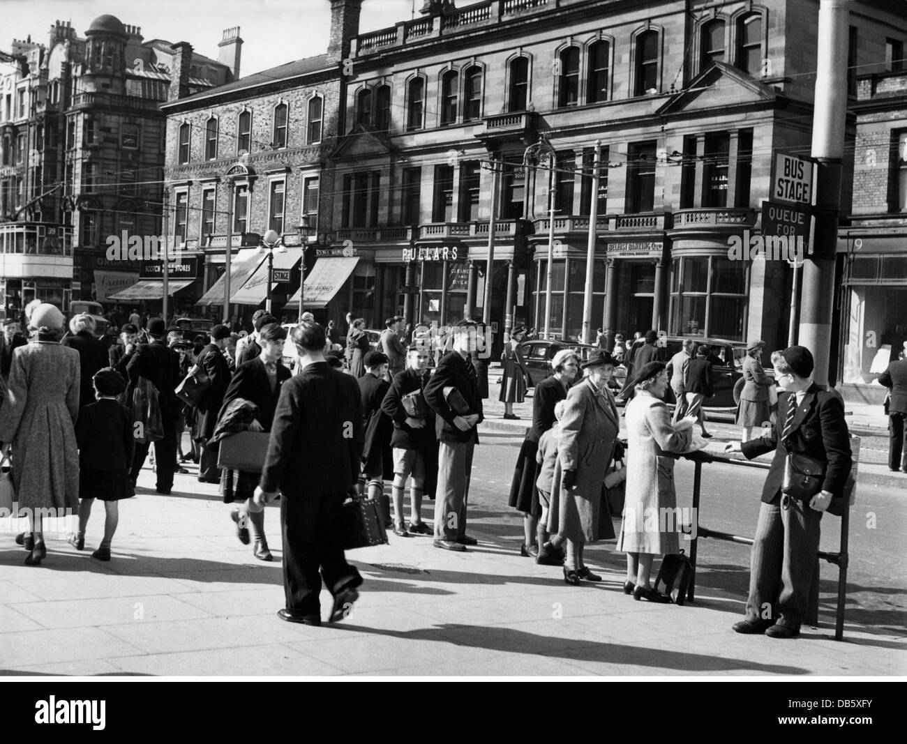 geography / travel, Great Britain, Belfast, street scenes, pedestrians at a bus stop, 1940s, 50s, 20th century, historic, historical, Northern Ireland, street scene, street scenes, pedestrian, pedestrians, passer-by, passerby, passers-by, stop, stops, inner city, midtown, city centre, town centre, urban core, people, Additional-Rights-Clearences-Not Available Stock Photo
