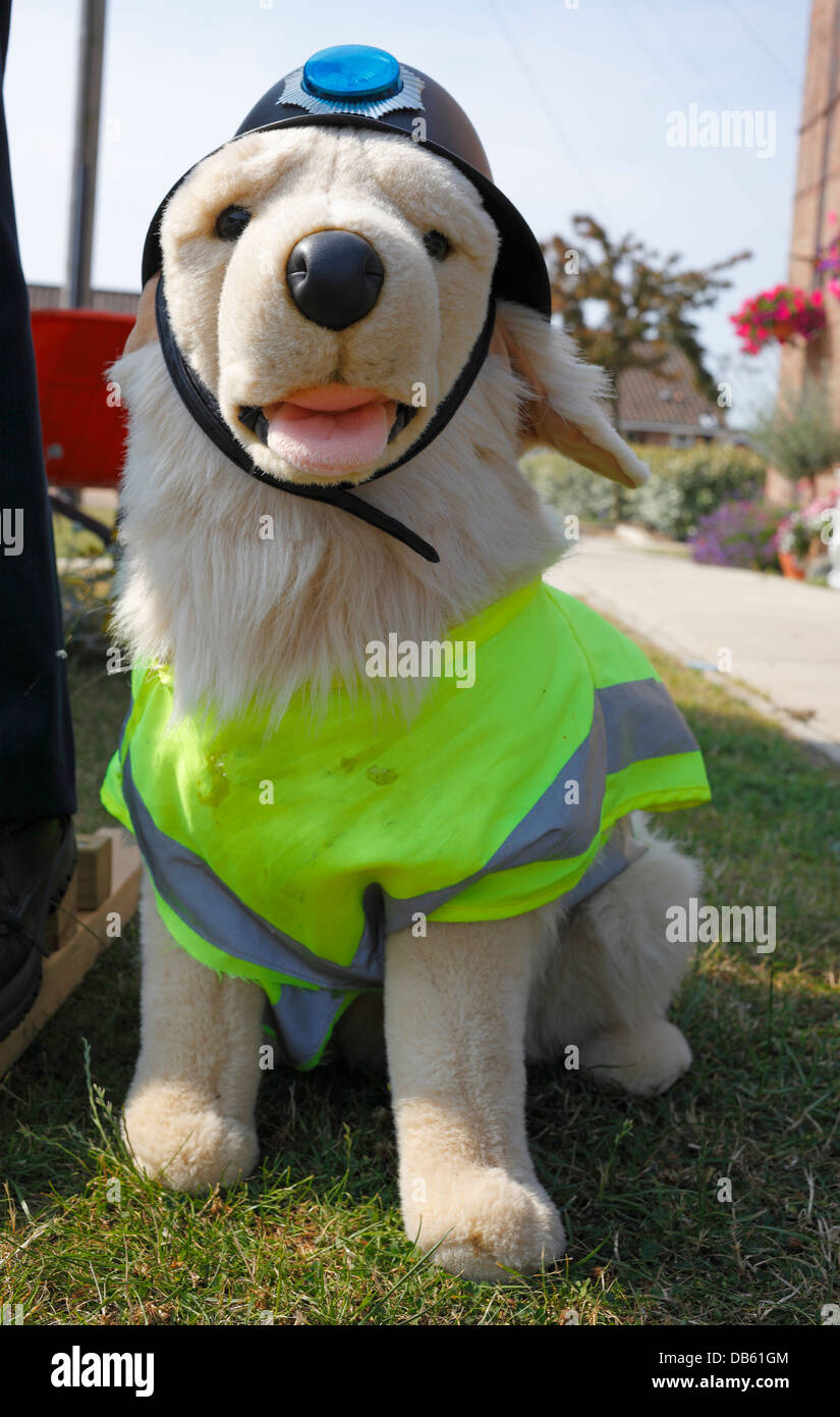 Stuffed dog toy dressed with a high visibility jacket and a police style helmet. Stock Photo
