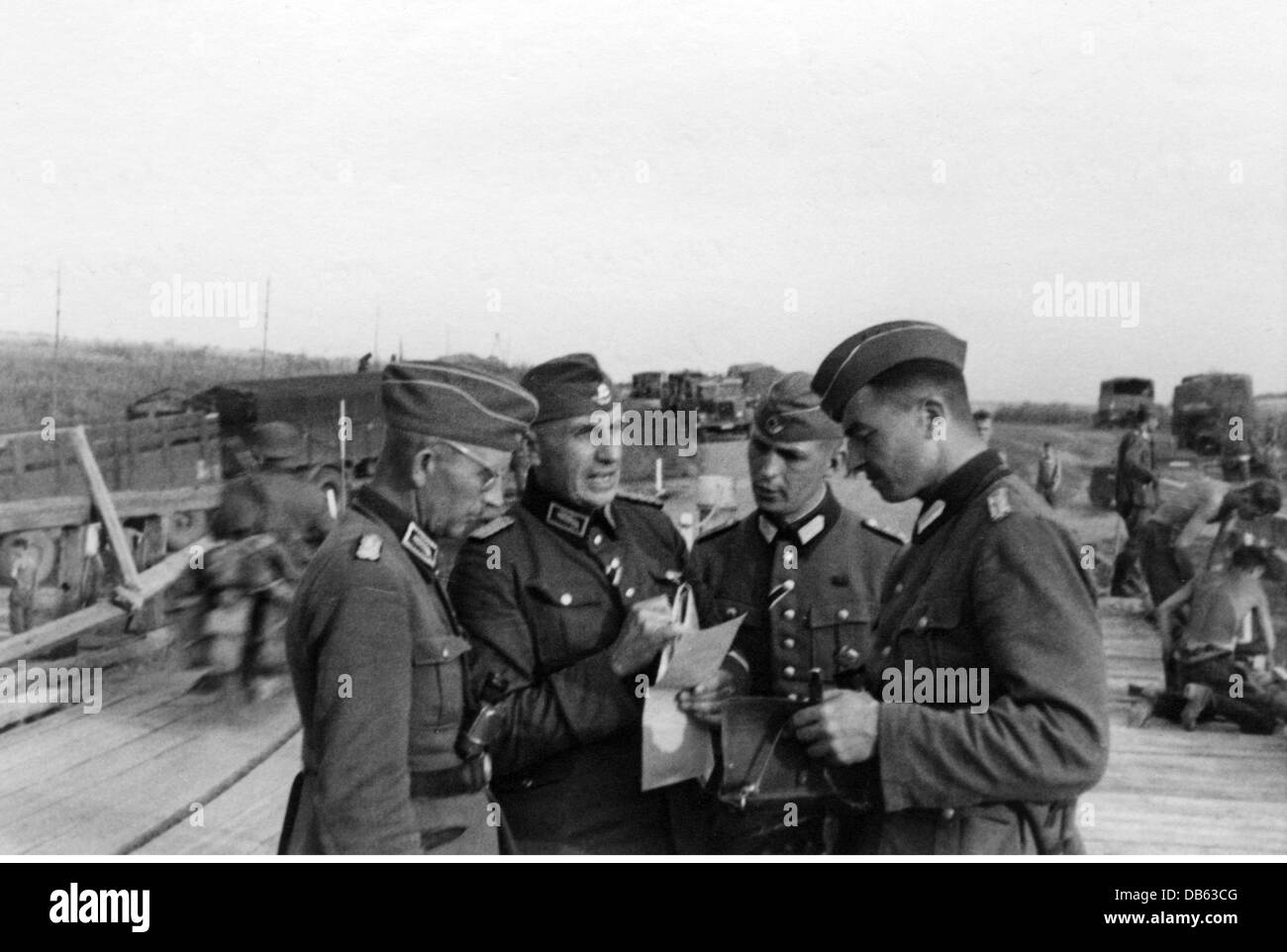 Nazism / National Socialism,organisations,Reich Labor Service(Reichsarbeitsdienst,RAD),RAD leaders during a briefing on the Eastern Front,photo taken by a member of RAD Abteilung K. 1/130,Ukraine,summer 1941,Soviet Union,German Reich,Third Reich,Germany,German Reich,Third Reich,1940s,40s,campaign,campaigns,German Invasion of the Soviet Union,Russian campaign,campaign in Russia,campaign in the East,uniform,uniforms,bridge construction,bridge,bridges,bridge,bridges,construction,building,under construction,historic,historical,peo,Additional-Rights-Clearences-Not Available Stock Photo