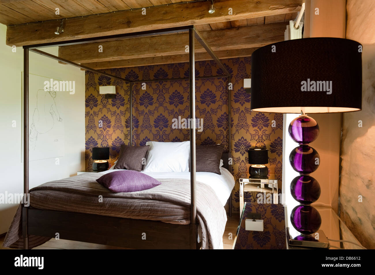 Dramatic 'Rostallan' wallpaper design on a copper coloured metallic  background with four poster bed from Ikea Stock Photo - Alamy