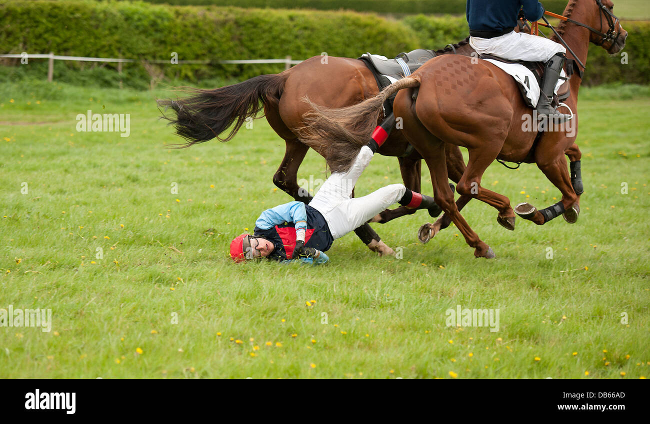 Jockey being dragged along by a horse during a race Stock Photo