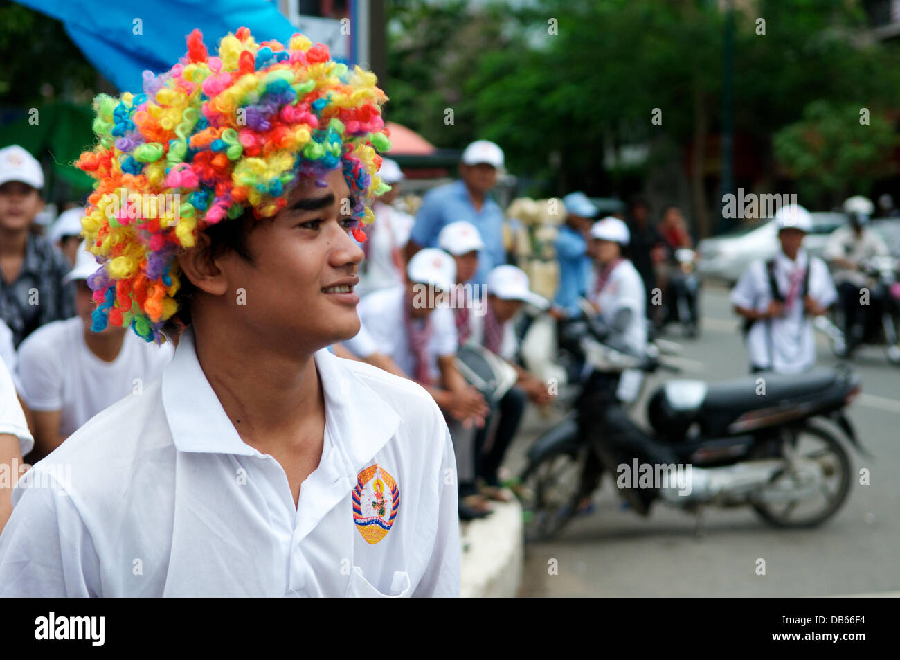 Phnom Penh, Cambodia on July 24th, 2013. Hun Sen supporter wearing colorful wig. Hun Sen is the current Prime minister of Cambodia & has been ruling for the last 28 years. Credit:  Kraig Lieb / Alamy Live News Stock Photo