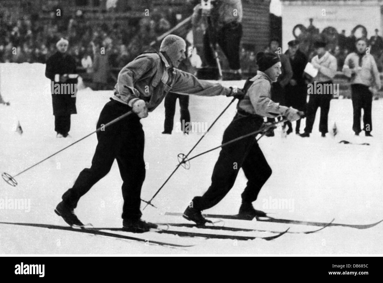 sports, Olympic Games, Garmisch-Partenkirchen 6.2.- 16.2.1936, nordic skiing, cross-country skiing, 4x10 km relay, Finnish team, Klaes Karppinen relieving Sulo Nurmela, Finnland, 4 x 10, champion, gold, winner, athlet, ski, Nazi Germany, Third Reich, winter games, IV olympiad, Garmisch Partenkirchen, 1930s, 30s, 20th century, historic, historical, people, Additional-Rights-Clearences-Not Available Stock Photo