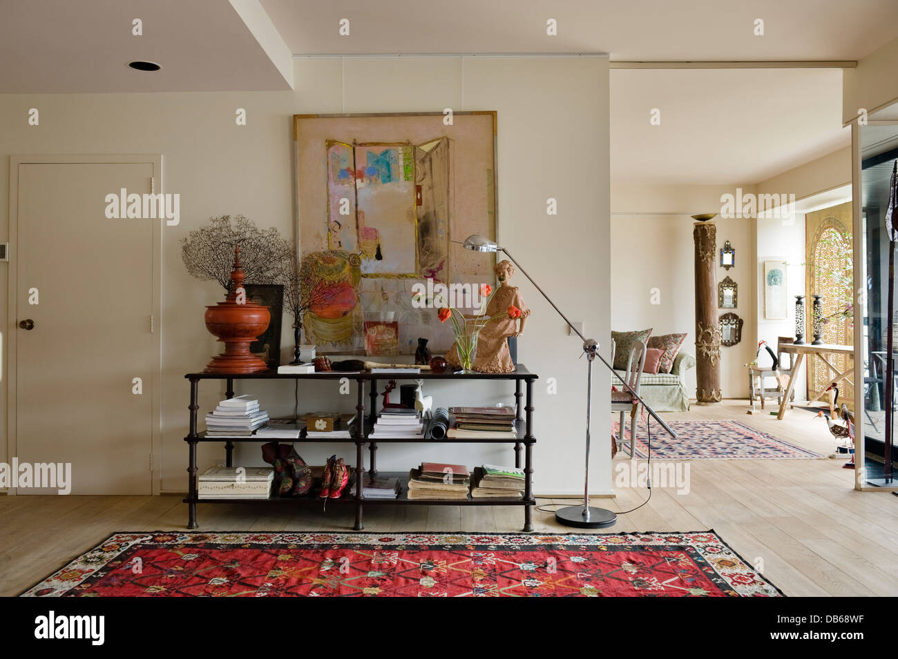 Openplan entrance hall with iron and timber table, painting by Pierre