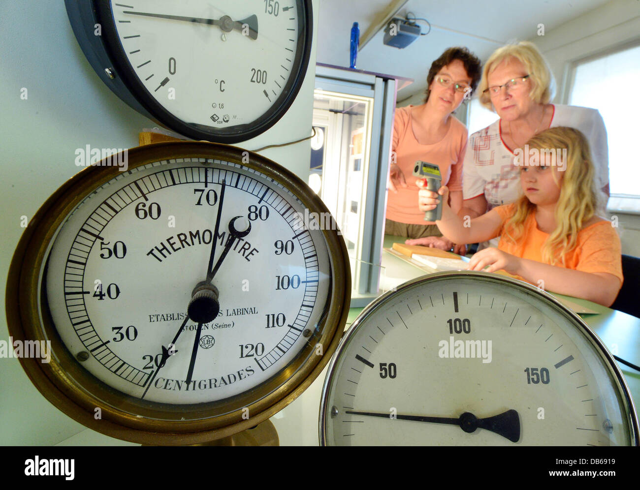 Visitors experiment in the German thermometer museum in Geraberg, Germany, 24 July 2013. The