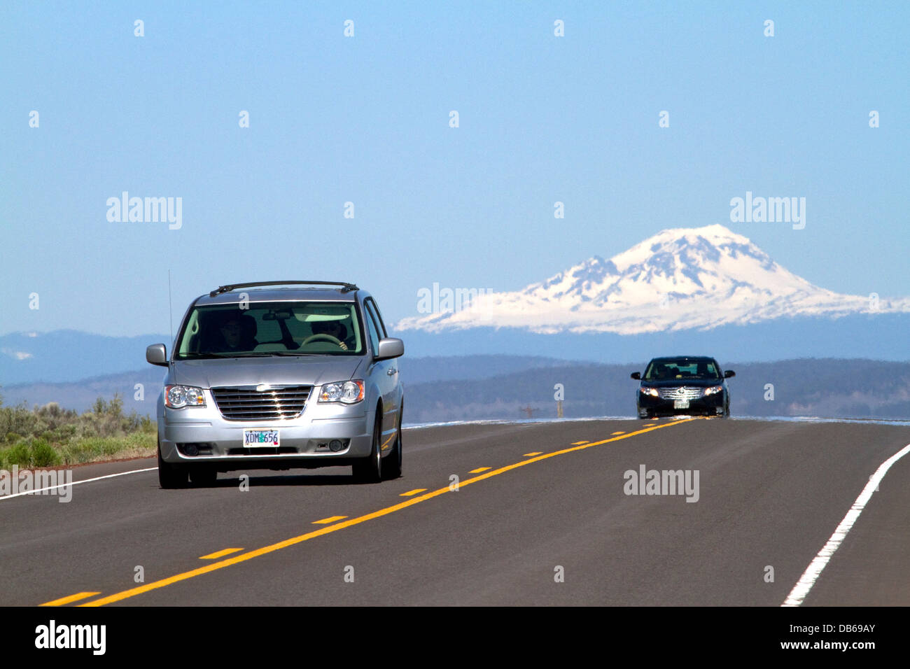 Automobiles travel on U.S. Route 20 east of Bend, Oregon, USA. Stock Photo