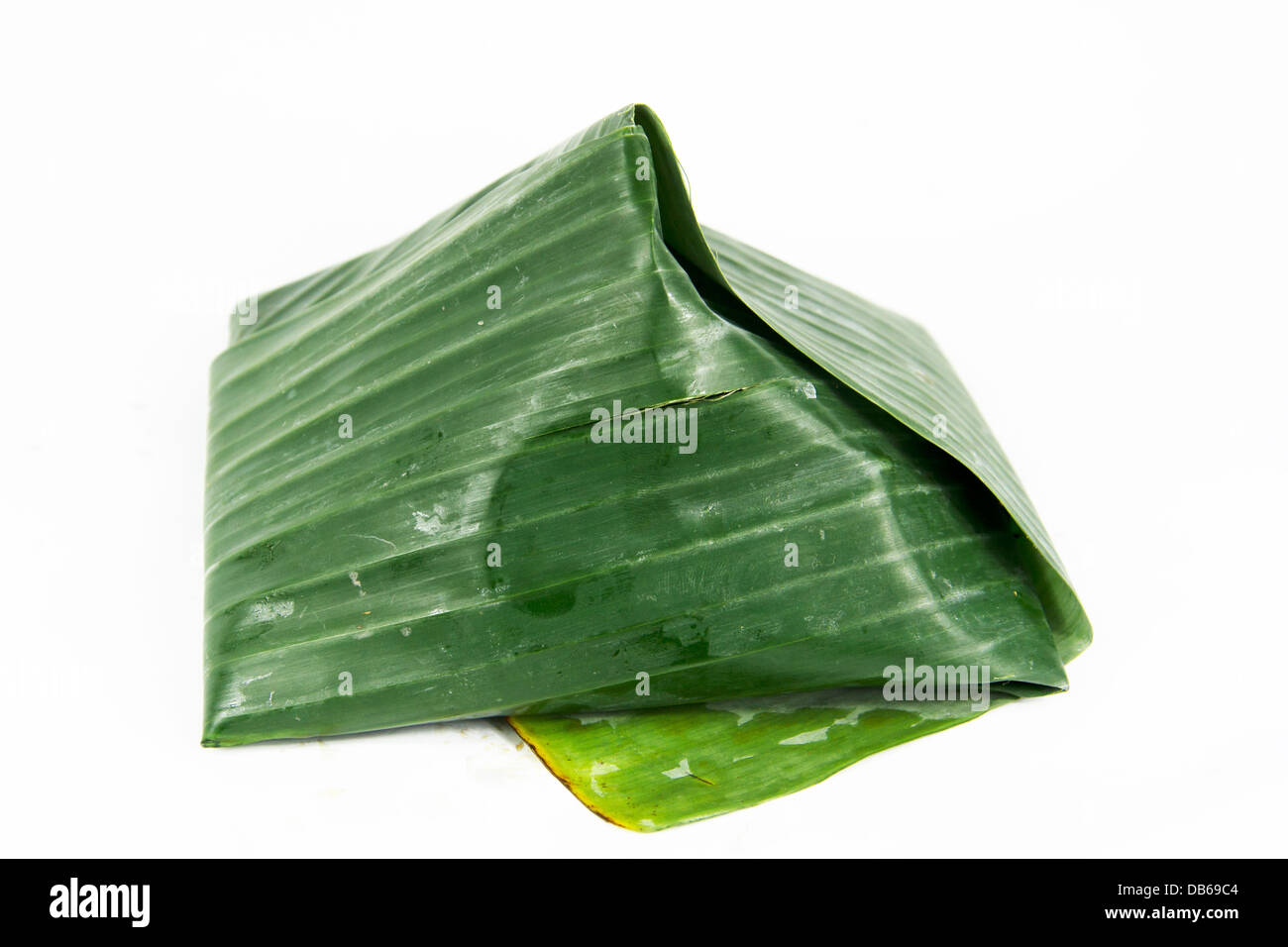 coconut rice 'nasi lemak' with sambal chilli wrap in banana leaves Stock Photo