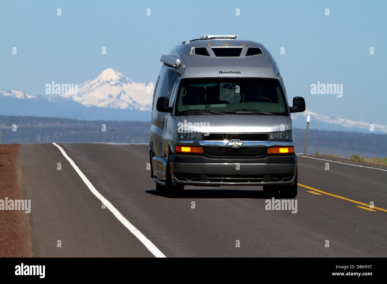 Automobile traveling on U.S. Route 20 east of Bend, Oregon, USA. Stock Photo