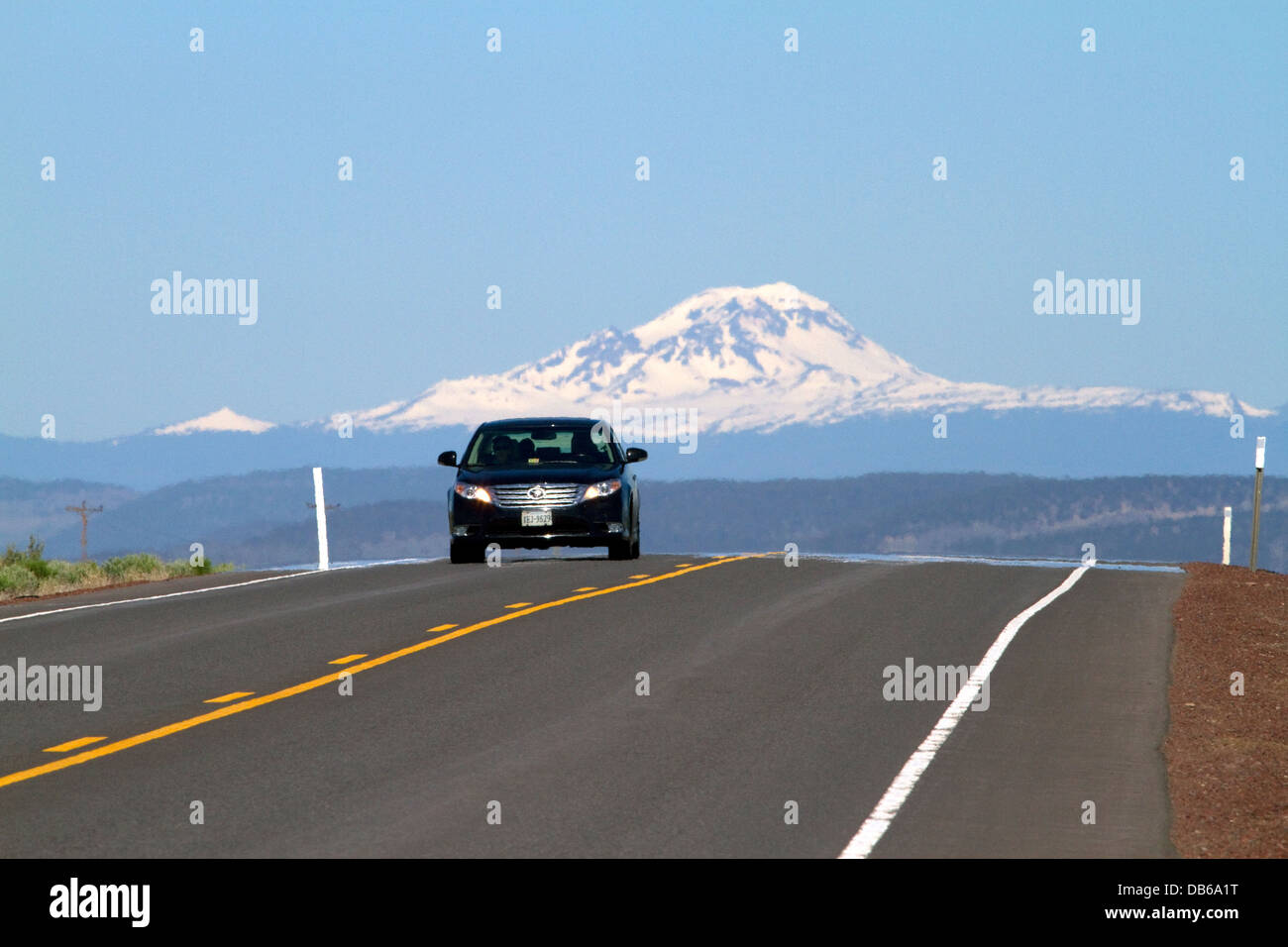 Automobile traveling on U.S. Route 20 east of Bend, Oregon, USA. Stock Photo