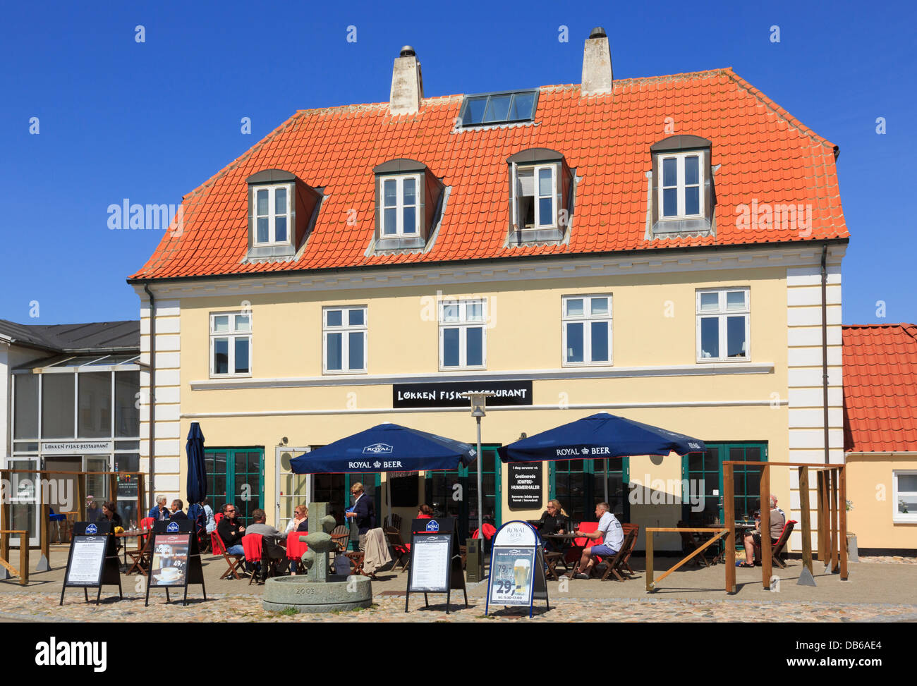 People dining outside the Fiske-Restaurant (Fish Restaurant) in Lokken, North Jutland, Denmark Stock Photo