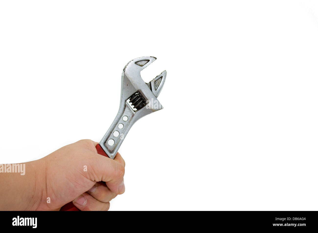 a thumb adjusting a adjustable wrench against white background Stock Photo