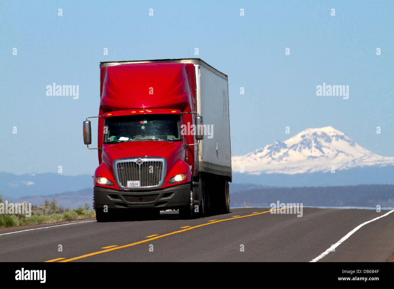 Semi truck traveling on U.S. Route 20 east of Bend, Oregon, USA. Stock Photo