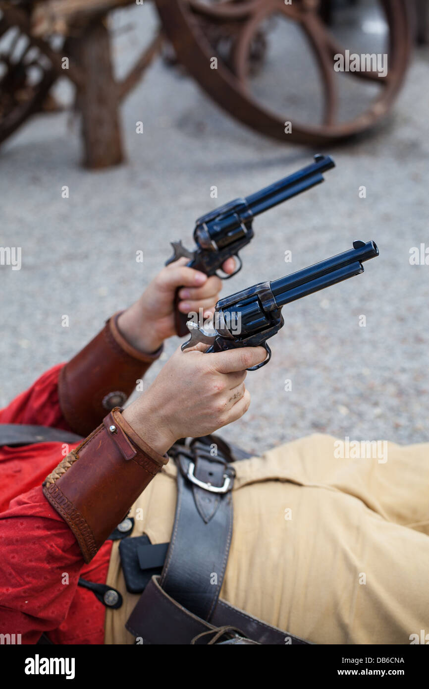 Cowboy with Hat and Guns Lying Down Stock Photo