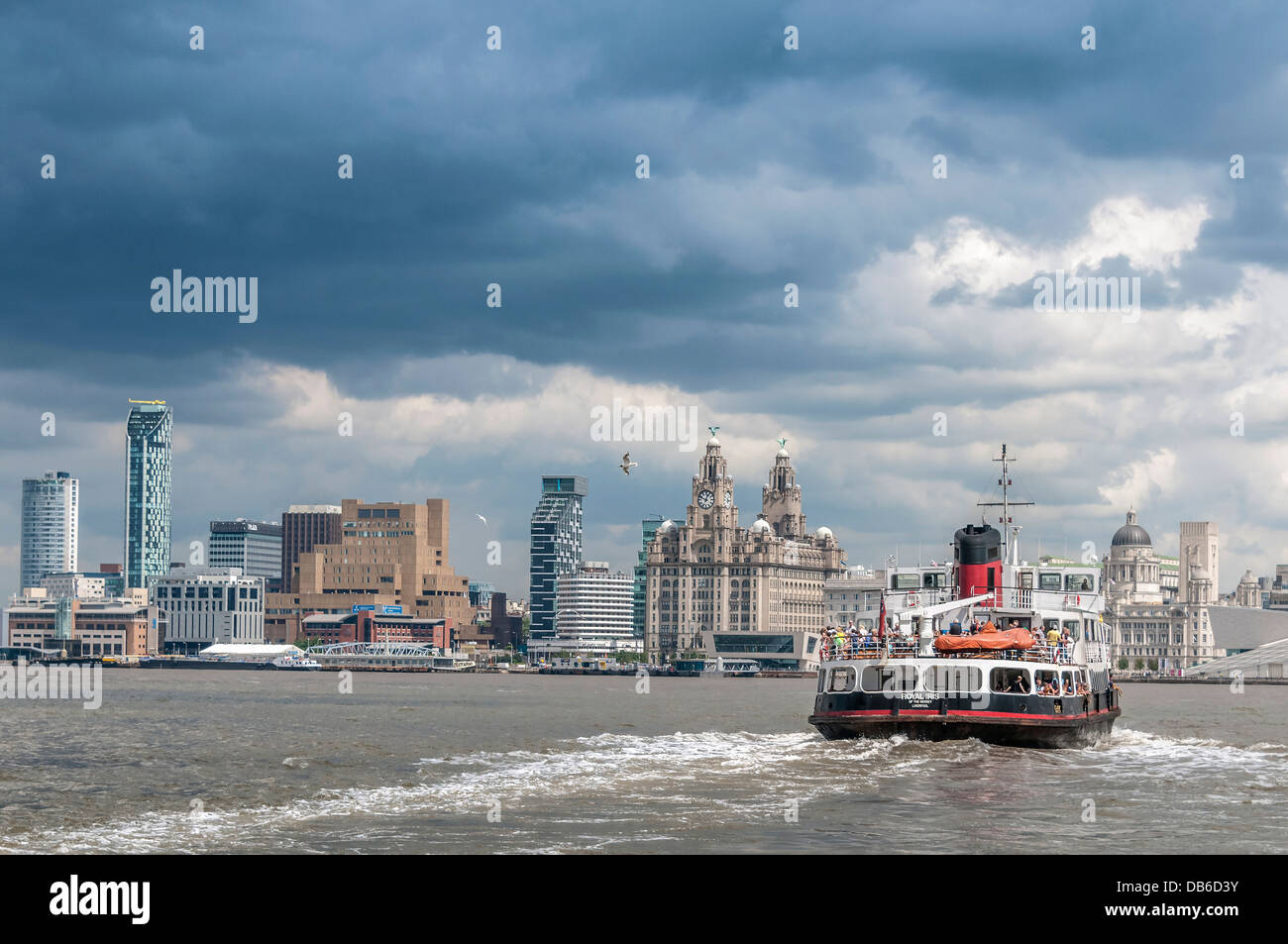 The river Mersey ferry Royal Iris seen from Woodside in Birkenhead with the Liverpool  waterfront skyline in the background. Stock Photo