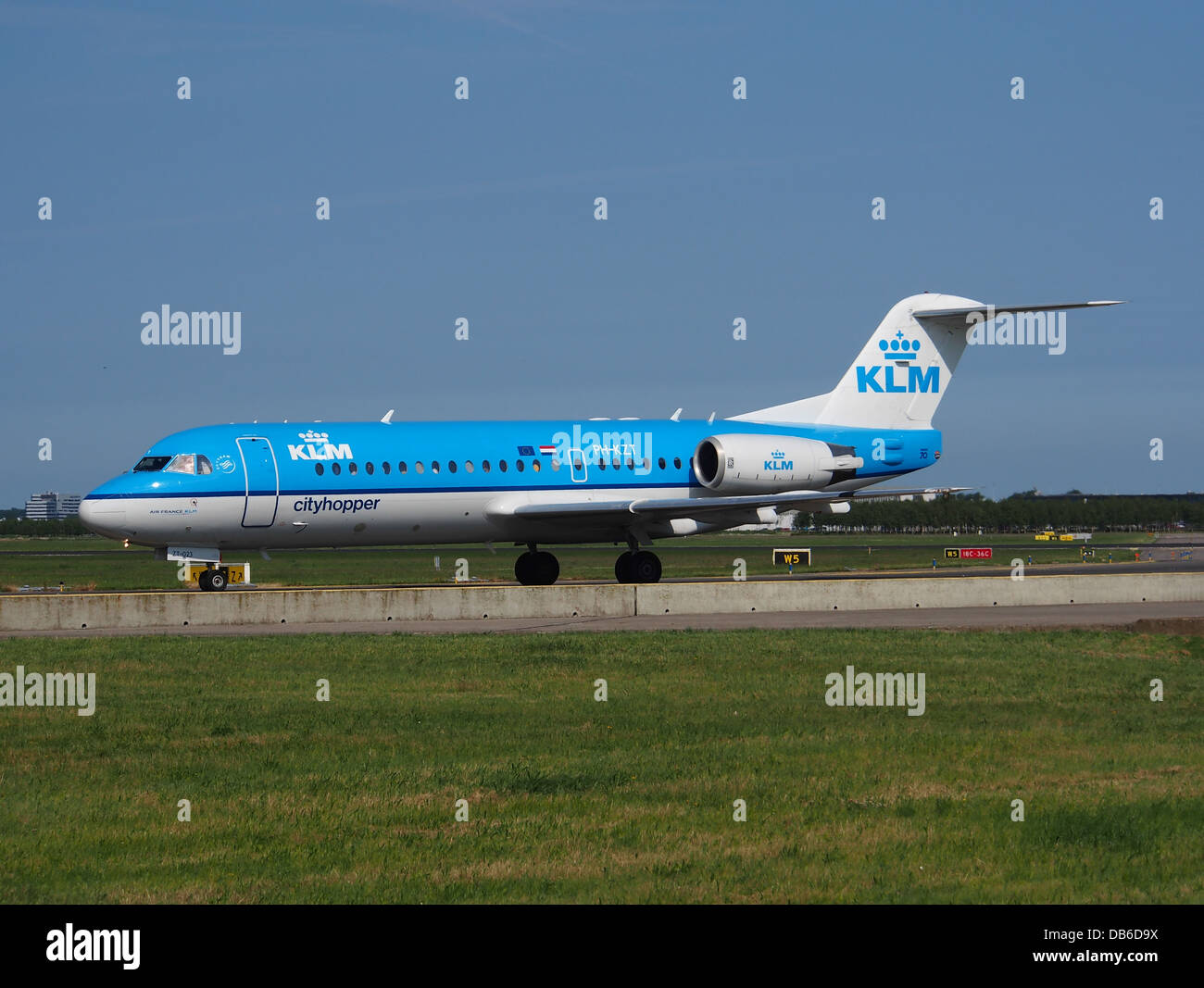 PH-KZT is a Fokker 70 operated by KLM Cityhopper, serving short-haul routes across Europe. The Fokker 70 is a regional jet designed for efficient travel between smaller cities and larger metropolitan hubs, offering quick and comfortable service. Stock Photo