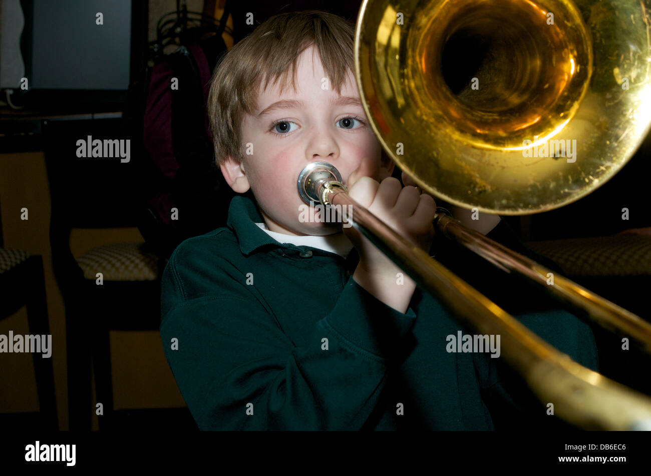 Boy plays trombone Stock Photo