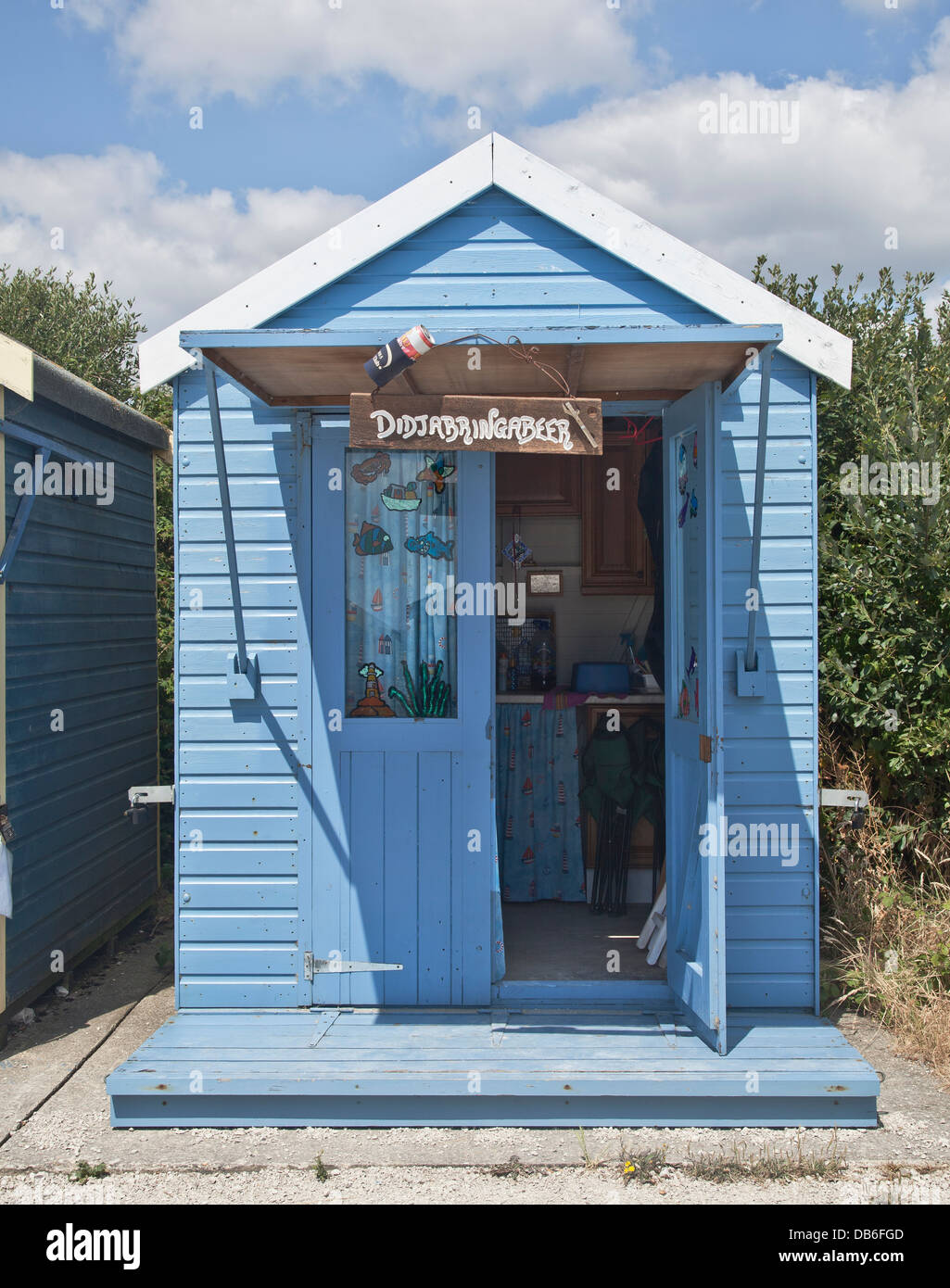 Blue beach hut with open oor Stock Photo - Alamy